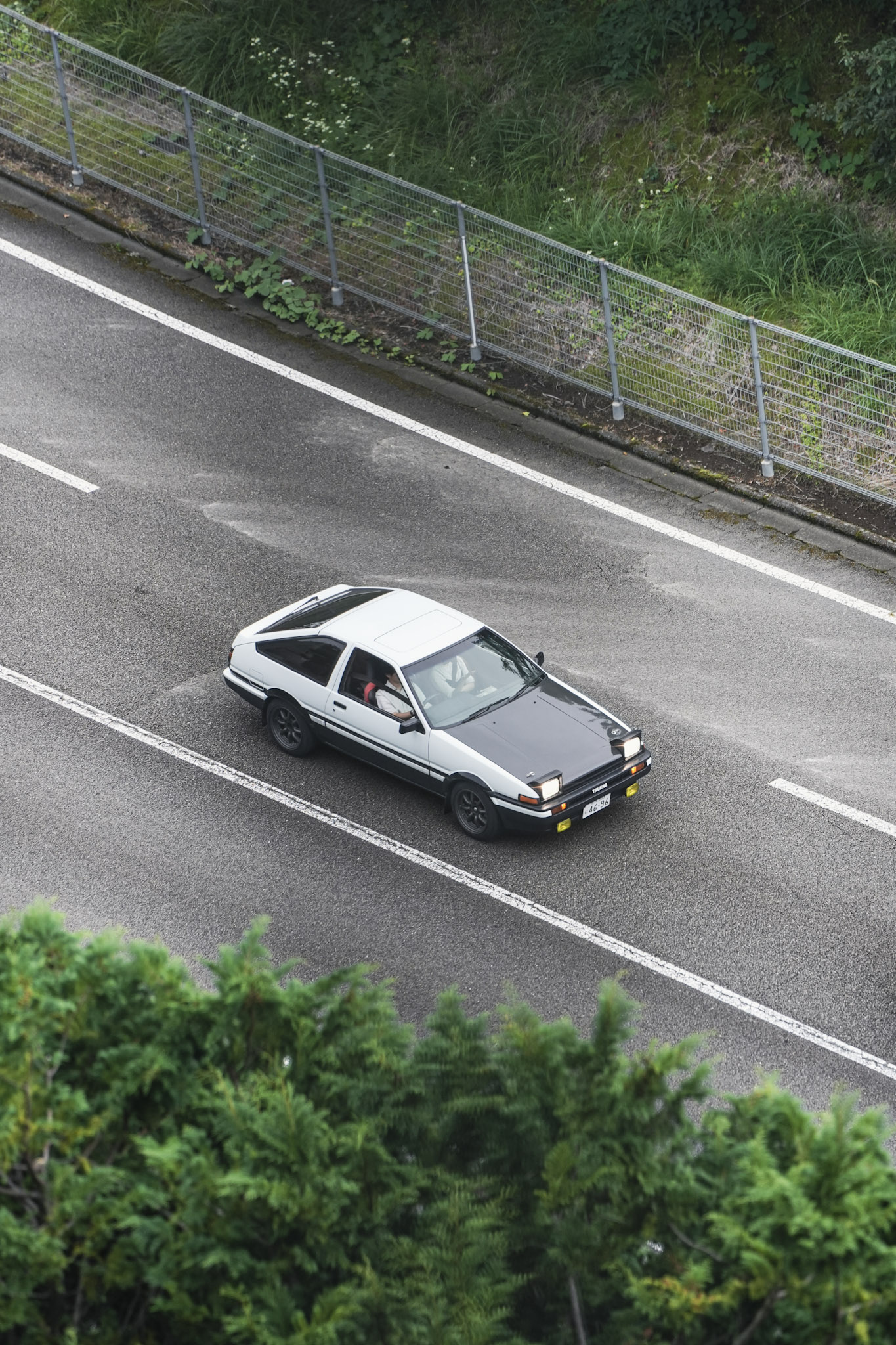 Toyota AE86 Trueno viewed from above on a rain-grey Fuji Speedway